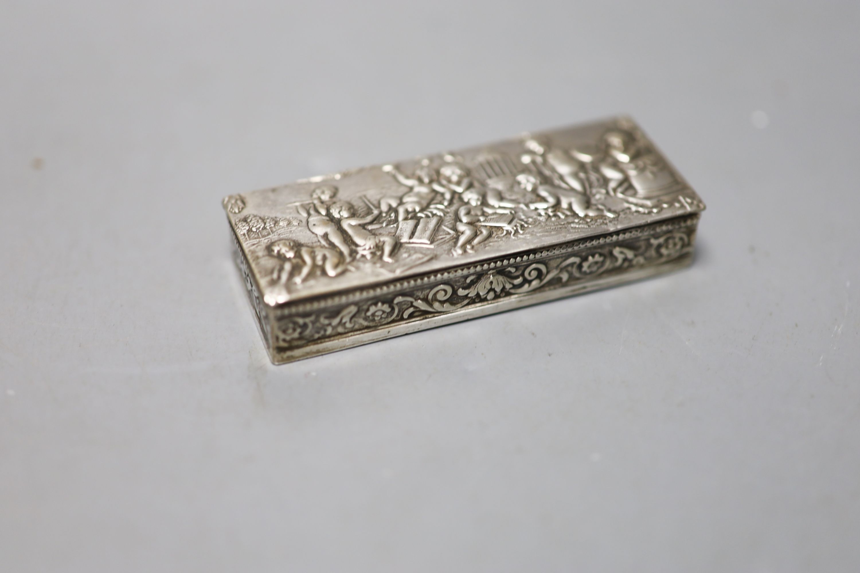 A late 19th century German embossed 800 standard white metal rectangular box, 12.2cm, three smaller boxes, including two silver and a match sleeve.